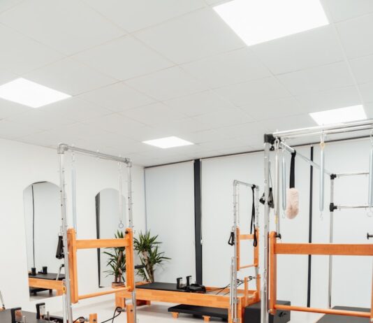 필라테스: 몸과 마음을 강화하는 완벽한 운동 a white room with mirrors and equipment in it