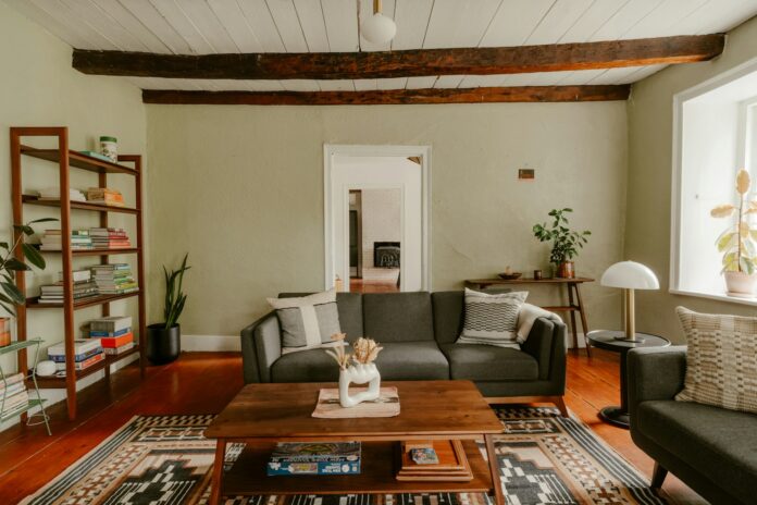 Living room with sofa, coffee table, and exposed beams
